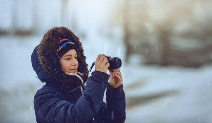 Canvas Print - Young Female Taking Pictures in Snowfall