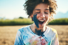 The Pain Can Exploded. Shot Of A Teenage Boy Having Fun With Colourful Powder At Summer Camp.