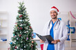 © Elnur - Young male doctor celebrating Christmas at the hospital