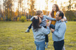 © Strelciuc - Parents with kids relaxing in the park. Family embracing