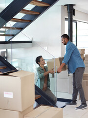 Sticker - Is this the last of them. Shot of a happy young couple passing boxes to each other while moving into their new home.