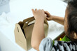 © Kanurism - Close-up of little girl assembling box craft. Eco-friendly disposable paper. Fast food container