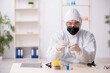 © Elnur - Young male chemist working at the lab during pandemic