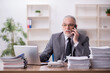 © Elnur - Old male employee working in the office