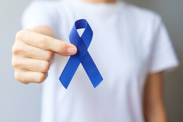 Wall Mural - March Colorectal Cancer Awareness month, Woman holding dark Blue Ribbon for supporting people living and illness. Healthcare, hope and World cancer day concept