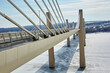 Modern bridge going across a large frozen river on a cold day in winter