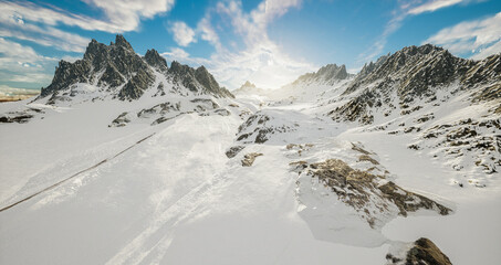 Snowy winter scenery with high moutains and snowflakes.