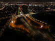 Amsterdam at night, dutch infrastructure road intersection, train, road,track, metro and pedestrians. Aerial drone view.