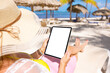 © Kaspars Grinvalds - Woman on tropical beach holding tablet in vertical screen orientation, blank tablet's screen mockup