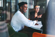 © Jacob Lund - Laughter in the meeting room. Group of young businesspeople having a discussion in a boardroom.