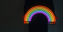 Girl Holds Neon Led Rainbow In Hands In The Night