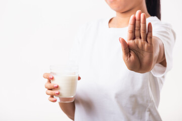 closeup woman raises a hand to stop sign use hand holding glass milk she is bad stomach ache has bad