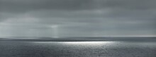 Panoramic View Of The Baltic Sea During The Storm. Dramatic Sky, Sun Rays Through The Dark Clouds. Epic Seascape. Finland. Concept Image, Ecology, Meteorology, Weather. Black And White, Silver Colors
