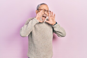 Poster - Handsome senior man with beard wearing casual sweater and glasses shouting angry out loud with hands over mouth