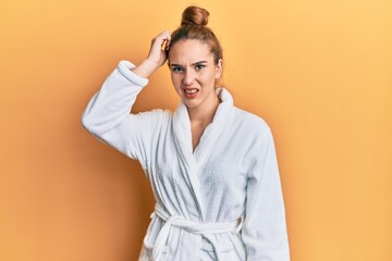 Poster - Young blonde woman wearing bathrobe confuse and wonder about question. uncertain with doubt, thinking with hand on head. pensive concept.