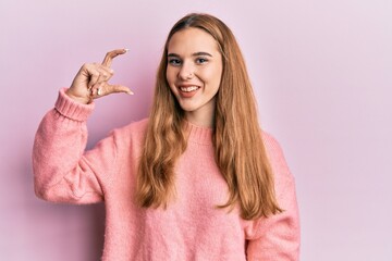 Sticker - Young blonde woman doing measure gesture with fingers winking looking at the camera with sexy expression, cheerful and happy face.