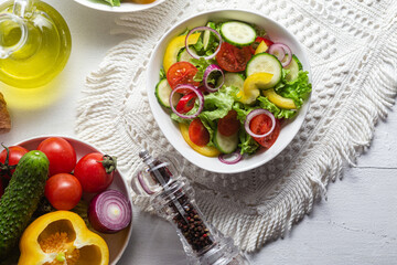 Wall Mural - Vegetable salad with cucumber, tomato, sweet pepper in a white plate