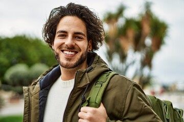 Sticker - Handsome hispanic man smiling at the park