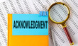 ACKNOWLEDGMENT text on sticker on notebook with magnifier and chart. Business concept