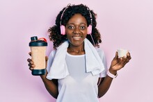 Young African American Woman Wearing Sport Clothes Drinking A Protein Shake Smiling With A Happy And Cool Smile On Face. Showing Teeth.