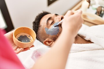 Sticker - Man reciving facial treatment at beauty center.