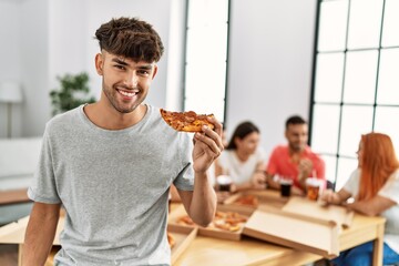 Sticker - Group of young people smiling happy eating italian pizza sitting on the table at home