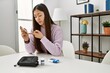 © Krakenimages.com - Young chinese girl measuring glucose sitting on the table at home.