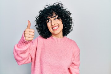 Sticker - Young middle east woman wearing casual clothes looking proud, smiling doing thumbs up gesture to the side