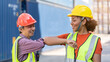 © Yellow Boat - Warehouse business. A Chinese man and a african american woman in safety suit elbow bump and conclude a job for transport and logistics after  Successfully completed business Contract