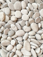 The Nature Texture Of The White Gravel Stone. Surreal Objects Photographed For A Background Collection. Rough Pattern Of The Mineral Surfaces.