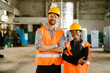 Multiracial man and woman smiling together while working at factory