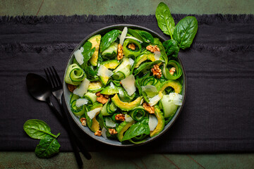 Poster - Spinach, avocado, cucumber, walnut and parmesan cheese salad. Top view.