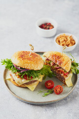 Wall Mural - Two burgers with veal cutlet and herbs on wooden cutting board