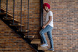 © zinkevych - Young indian man in red turban standing on stairs