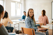 © Drazen - Happy teenage girl looking at camera during lecture at high school.