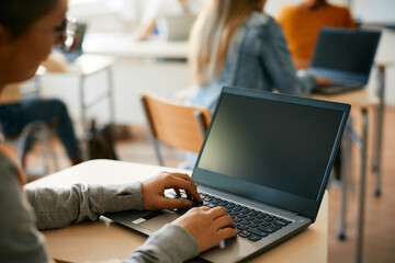 Wall Mural - Close-up of high school student using laptop during computer class at school.