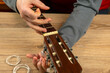 Changing nylon strings on a six-string classical guitar. instruction for musician
