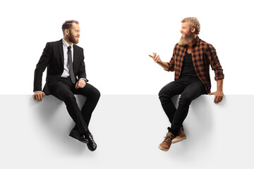 businessman and a bearded casual guy sitting on a panel and having a conversation