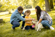 © BGStock72 - Happy family with cute bichon dog in the park