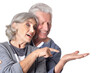 © aletia2011 - Portrait of happy senior couple pointing on white background