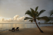 Belize, Placencia, Lounge Chairs On Tropical Beach At Sunset
