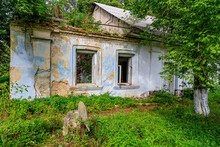 Ruined And Abandoned Rural House. The Concept Of A Dying Village And Global Urbanization. Background With Copy Space