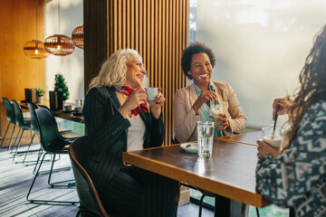 Wall Mural - Diverse female friends at cafe