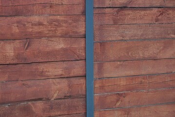 Sticker - brown red wooden texture from old  boards with black metal plate in the fence wall