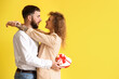 © Pixel-Shot - Happy couple with gift for Valentine's Day on color background
