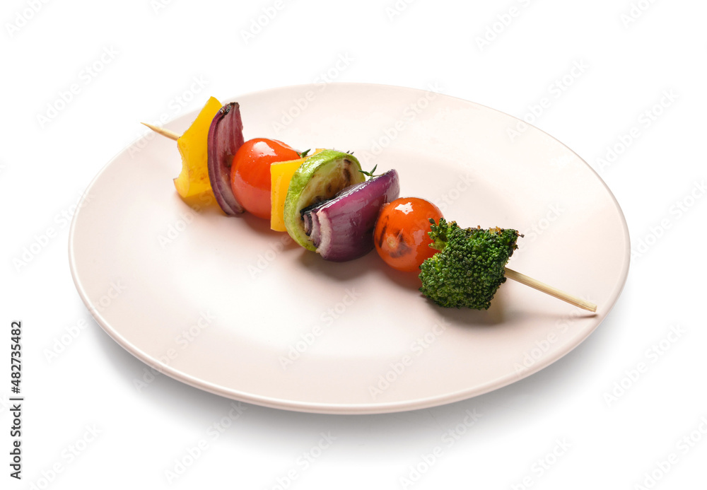 Plate with tasty vegetable skewer on white background