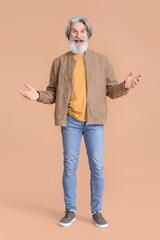 Poster - Surprised senior man in stylish jacket on beige background