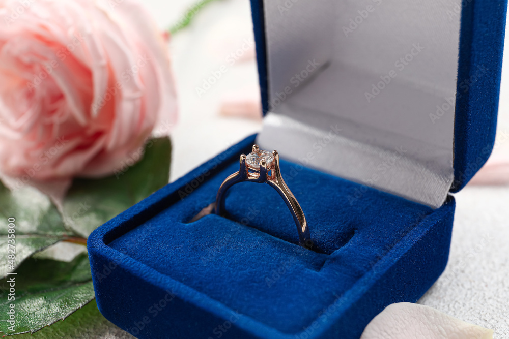 Box with beautiful golden engagement ring, closeup