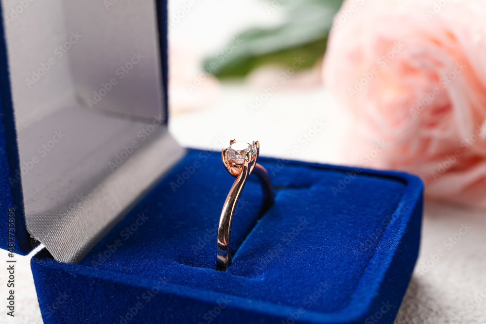 Box with beautiful golden engagement ring, closeup