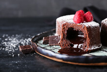Plate With Tasty Lava Cake Fondant And Raspberry On Dark Background, Closeup